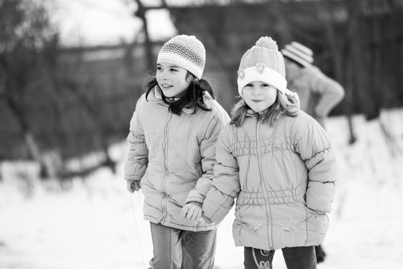 Small southern romanian village. Scenes from a moody winter with children playing with sledges and enjoying the snow