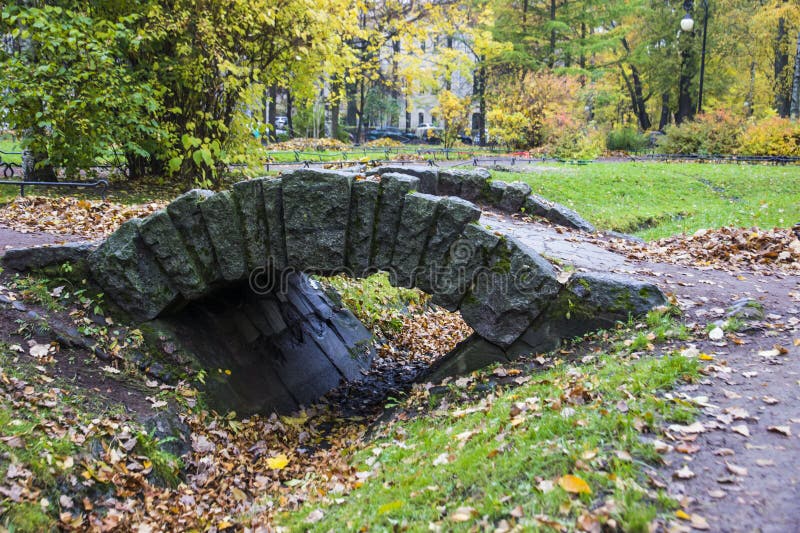 A small stone bridge over a ditch stock image