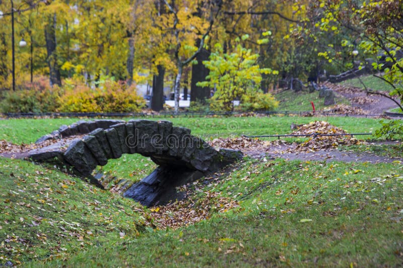 A small stone bridge over a ditch stock photo