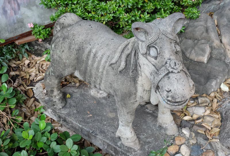 A Small Stone Garden Sculpture Depicting a Pony Stock Photo Image of themes, grass 165101636