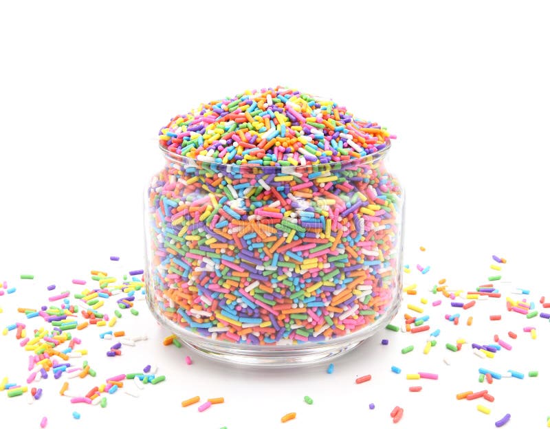 Small sugar candies rainbow in glass jar. Sweet treats for garnishing, donuts, and cakes at birthday parties.