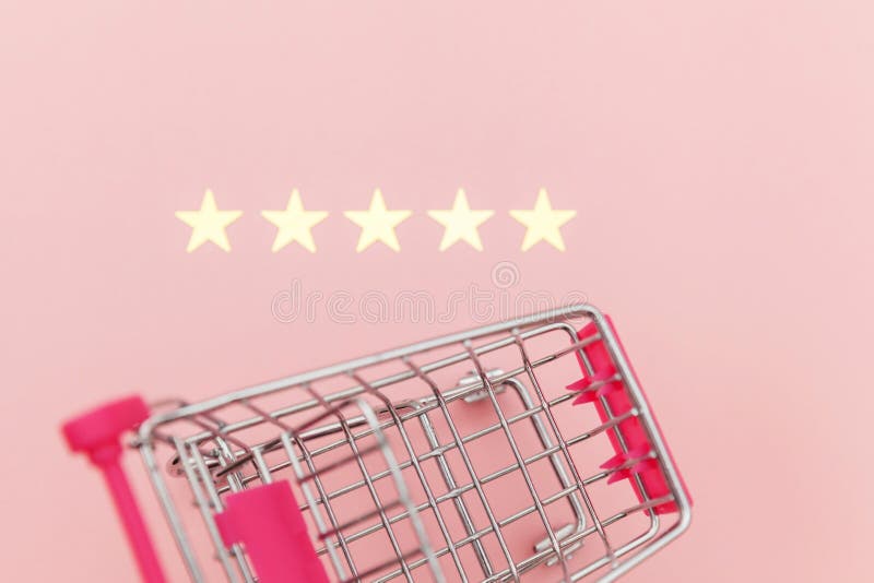 Small supermarket grocery push cart for shopping toy with wheels and 5 stars rating isolated on pastel pink background. Retail