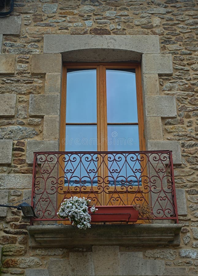 Small terrace with balcony door on old stone house stock photos