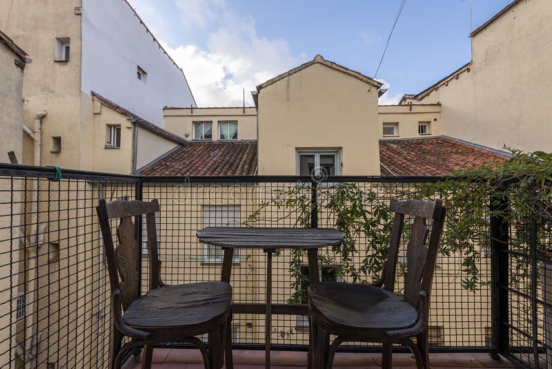 Small terrace with vines and a wooden table royalty free stock photography