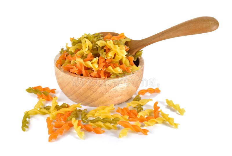 Small vegeroni Rotini spirals pasta in wooden bowl on white back stock photos