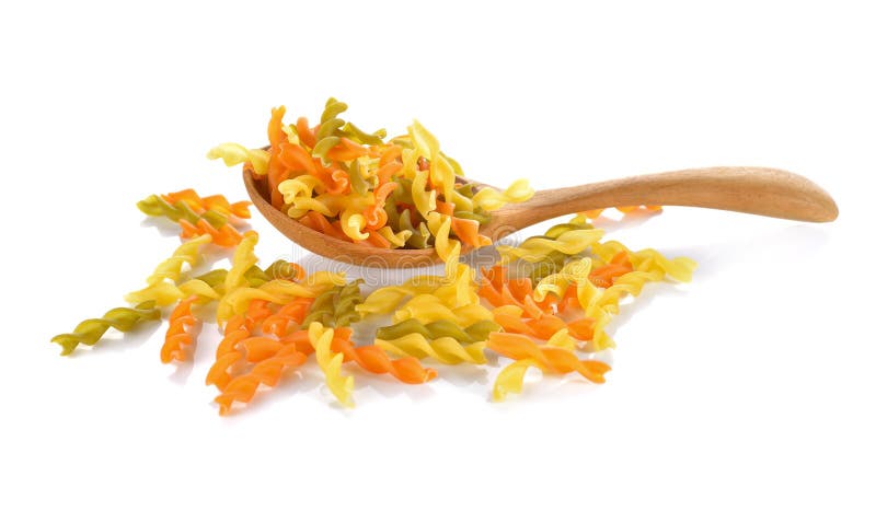 Small vegeroni Rotini spirals pasta in wooden spoon on white background royalty free stock photography