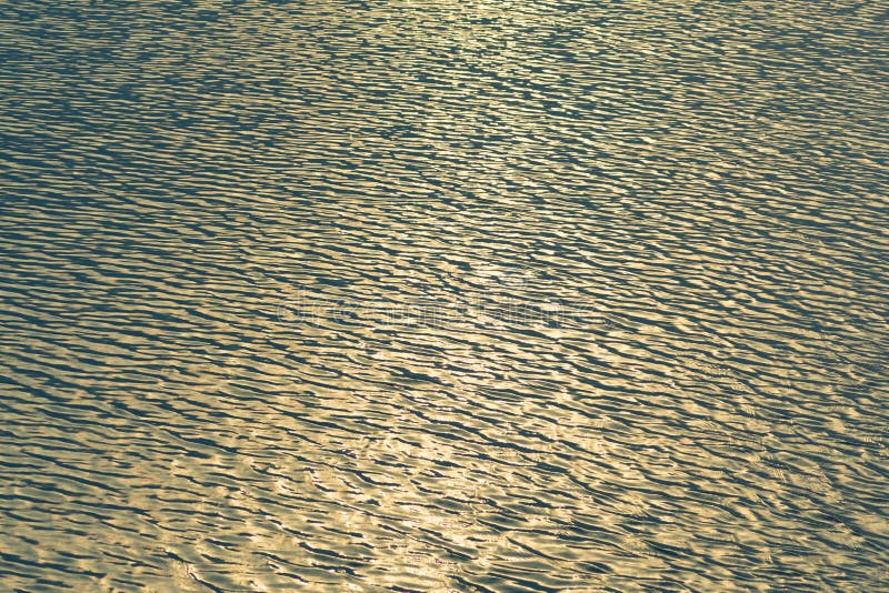 Small waves abstract or rippled water texture background, lake, sea or river