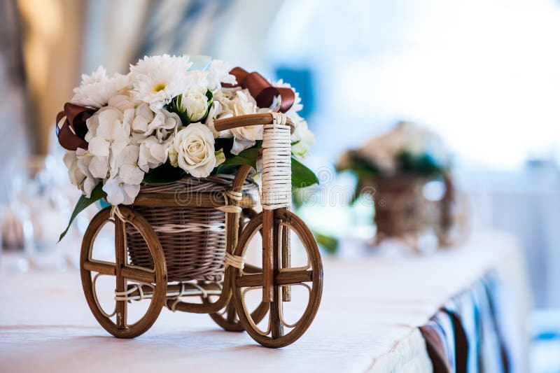 Small Wicker Bicycle with Basket and Flowers As Part of Wedding