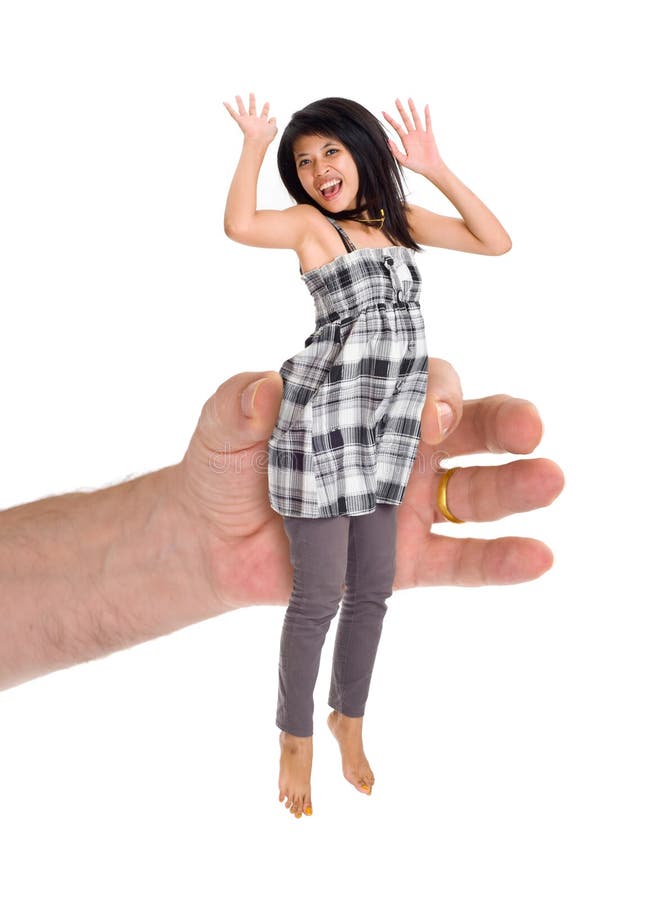 A huge hand holding a small asian woman.