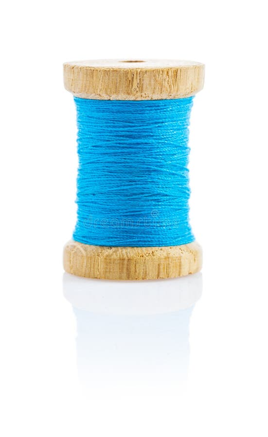 A small wooden bobbin with blue thread