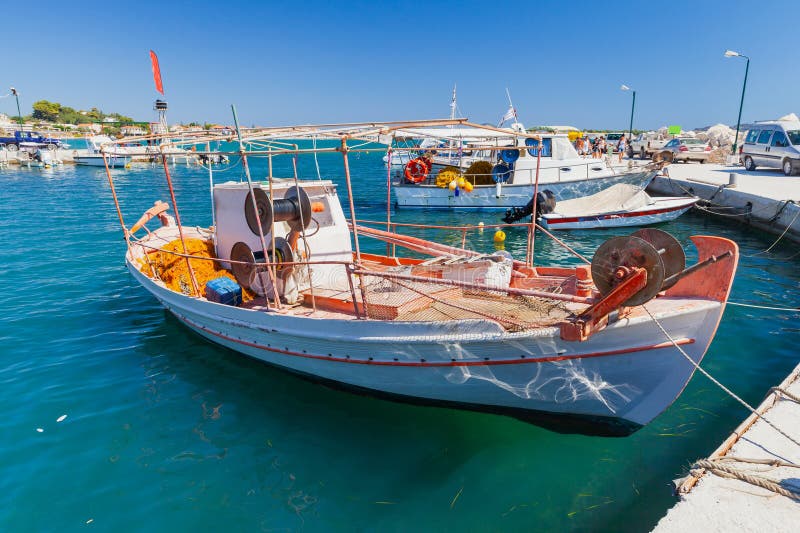 https://thumbs.dreamstime.com/b/small-wooden-fishing-boat-moored-port-agios-sostis-village-small-wooden-fishing-boat-moored-port-agios-sostis-village-271345498.jpg