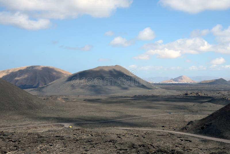 Small yellow car drives up the volcano royalty free stock photo Small yellow car drives up the volcano royalty free stock photo