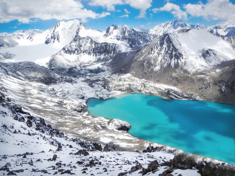 Smaragd water of misty Ala Kul lake in Terskey Alatoo mountain