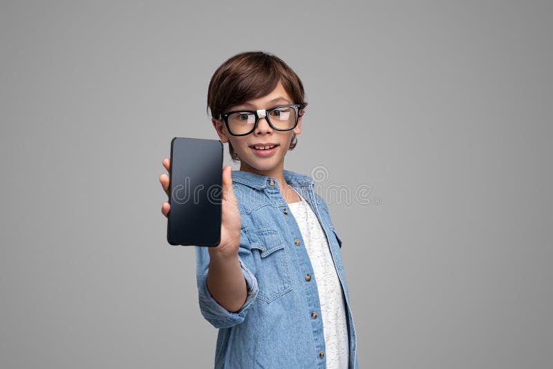 Smart boy demonstrating smartphone