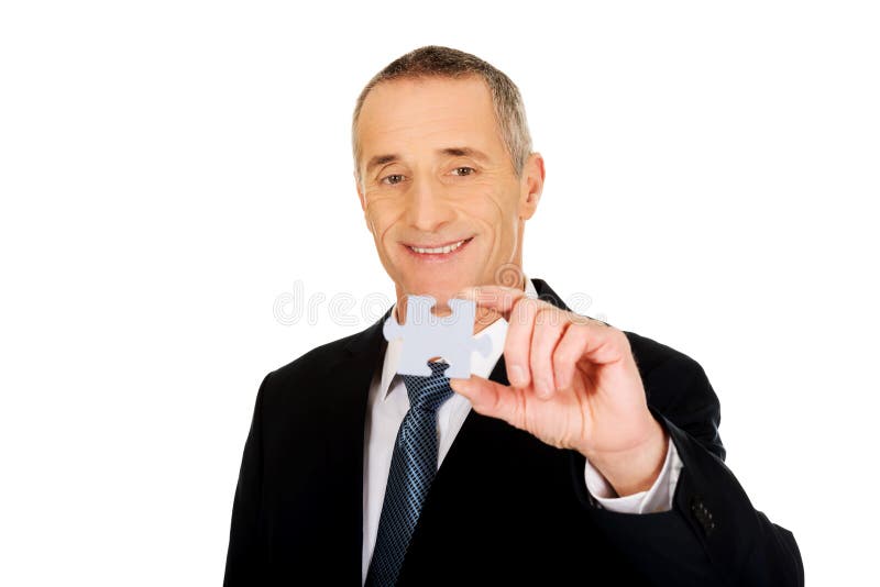 Smart businessman holding a puzzle