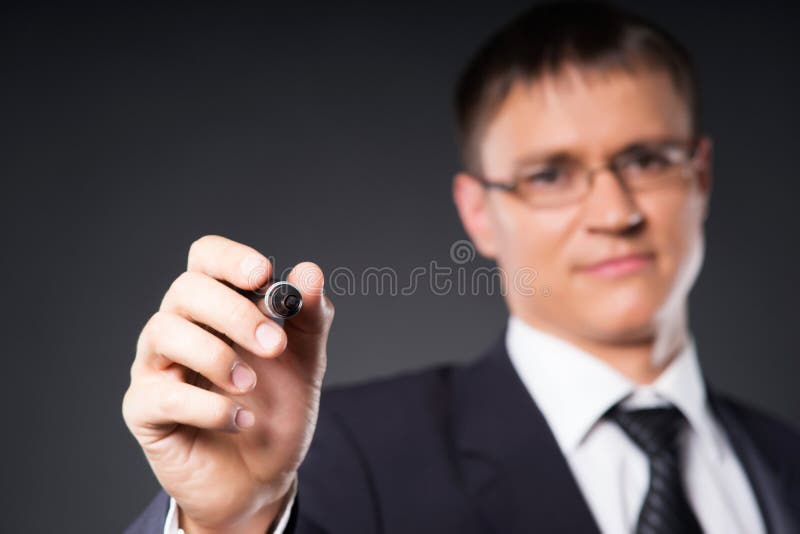 A smart businessman writing with a marker on the screen royalty free stock photography