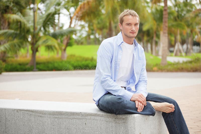 Smart casual man sitting in the park