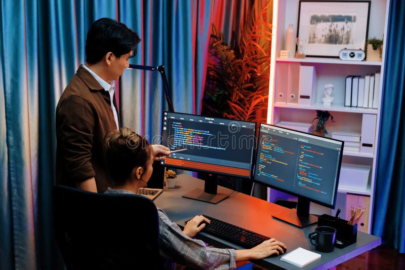 Smart IT developer looking at coding program application on computer screen of online website at back side, analyzing intelligent database system development on business marketing at office. Infobahn. Program coding working stock images, royalty-free photos and pictures