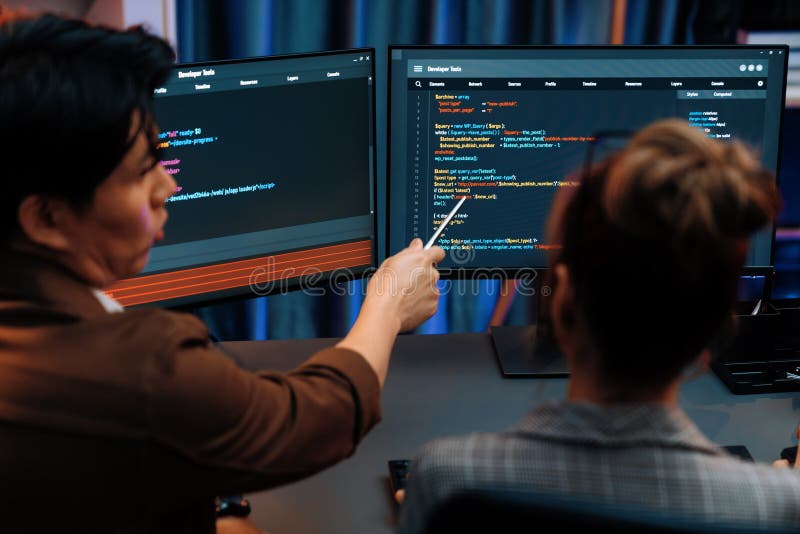 Smart IT developer looking at coding program application on computer screen of online website at back side, analyzing intelligent database system development on business marketing at office. Infobahn. Program coding working stock images, royalty-free photos and pictures