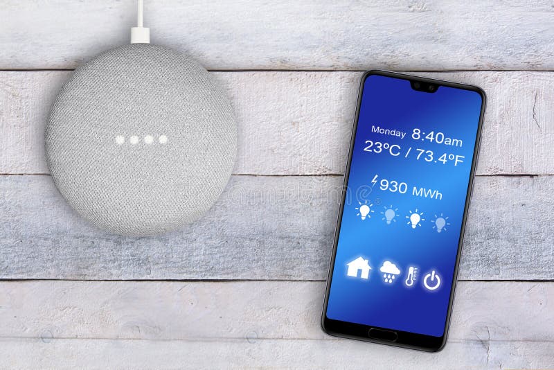 Smart home assistant controlled with a smart phone app on a white wooden table. Empty copy space royalty free stock photos