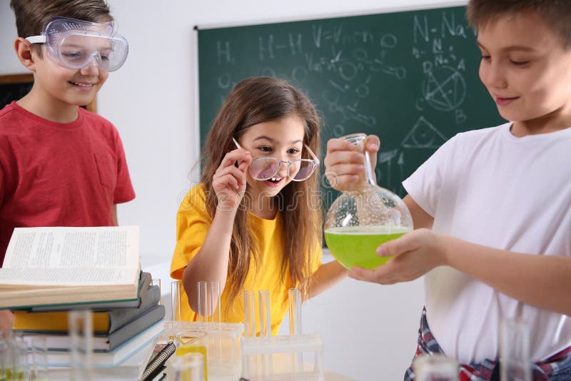 Smart pupils making experiment in class royalty free stock photo