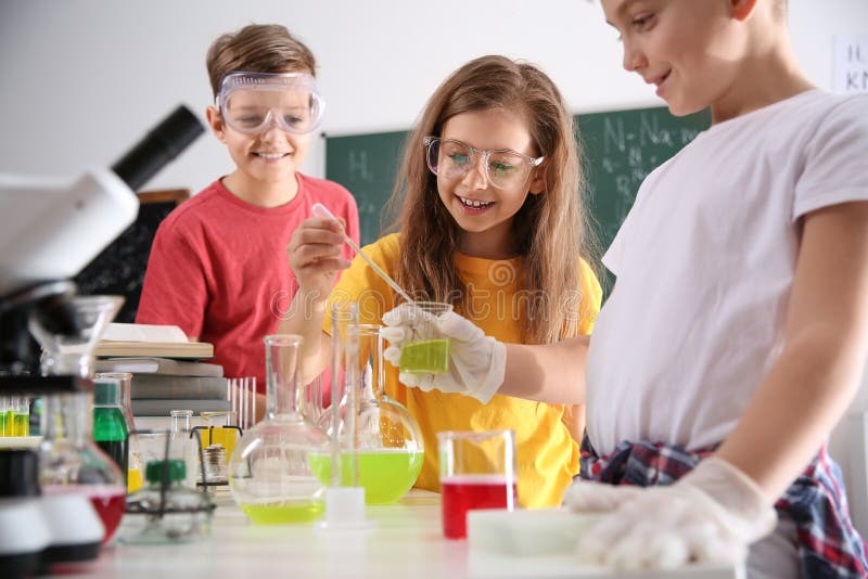Smart pupils making experiment in class royalty free stock photography