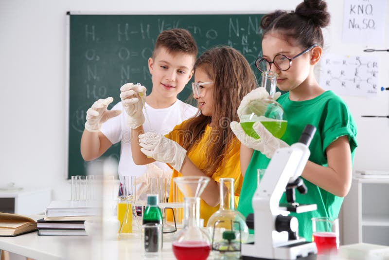 Smart pupils making experiment in class royalty free stock photos