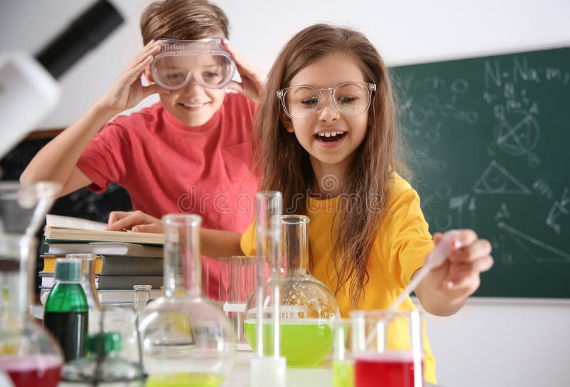 Smart pupils making experiment in class royalty free stock photography