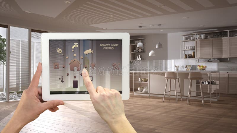 Smart remote home control system on a digital tablet. Device with app icons. Minimalist modern bright kitchen in the background stock image