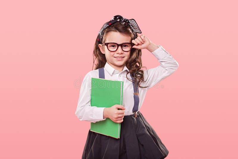 Smart schoolgirl adjusting trendy glasses