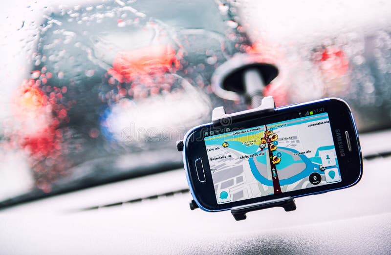 Smart phone with a Waze GPS navigator on the screen. Waze is one of the world's largest community-based traffic and navigation apps. Smart phone with a Waze GPS navigator on the screen. Waze is one of the world's largest community-based traffic and navigation apps