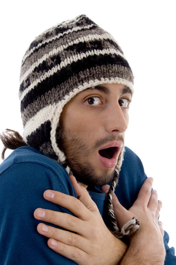 Smart young guy in winter cap shivering from cold