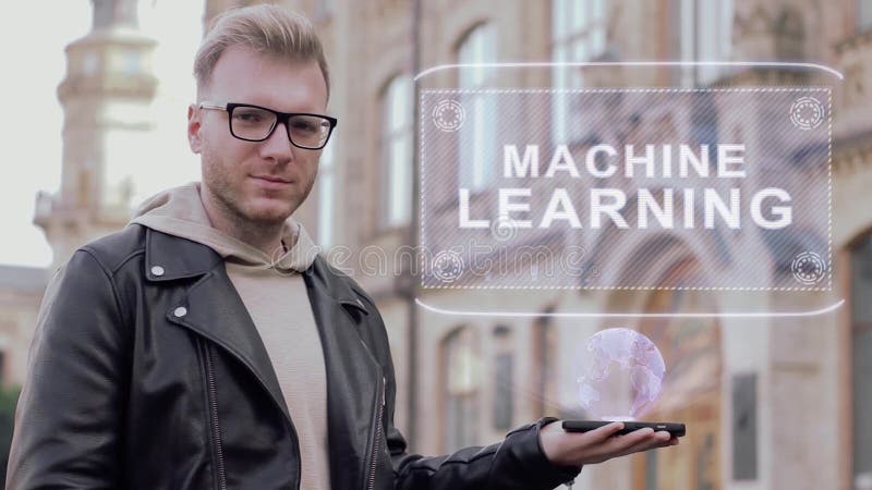 Smart young man with glasses shows a conceptual hologram Machine Learning