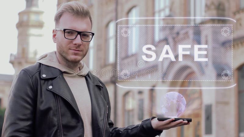 Smart young man with glasses shows a conceptual hologram Safe