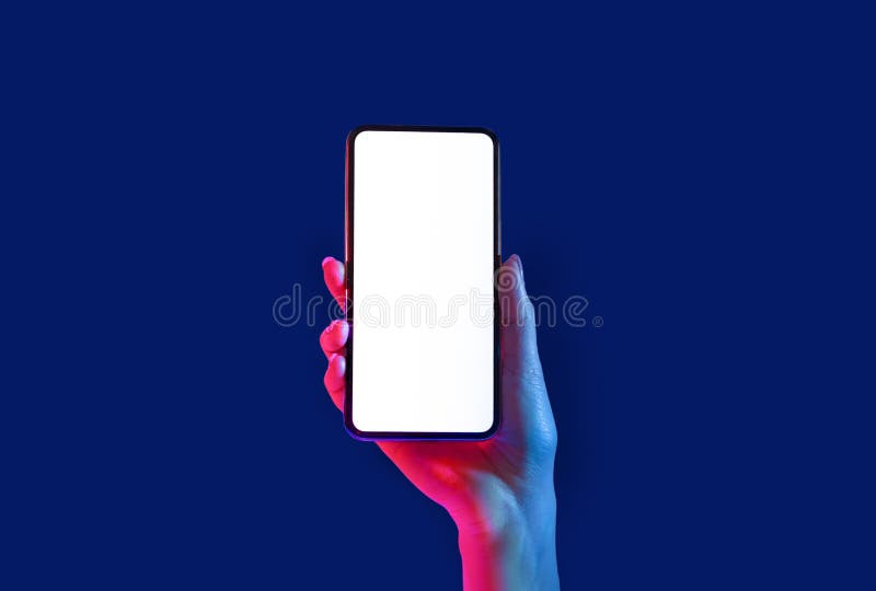 Smartphone in neon. Woman hand holds phone with empty screen isolated on blue background, close up, copy space. Smartphone in neon. Woman hand holds phone with empty screen isolated on blue background, close up, copy space