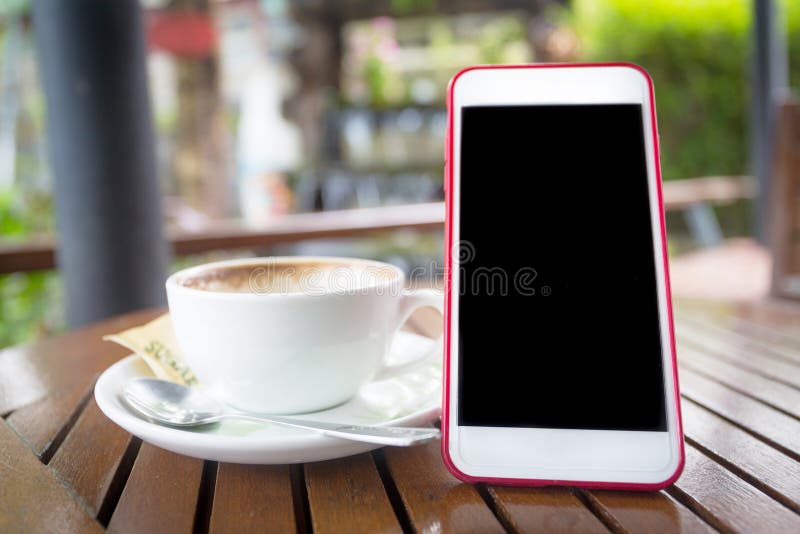 Smartphone with blank black screen and coffee cup