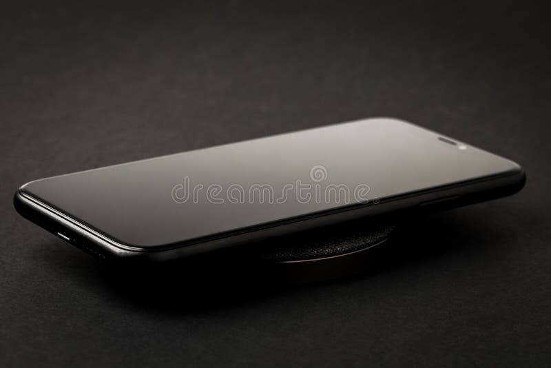 The Smartphone is Charged by a Wireless Charger Concept of New