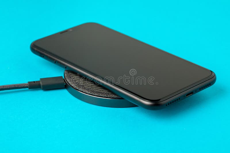 The Smartphone is Charged by a Wireless Charger Concept of New