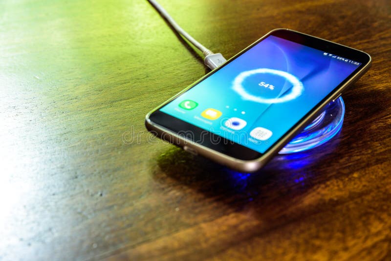 Smartphone charging on a charging pad. Wireless charging