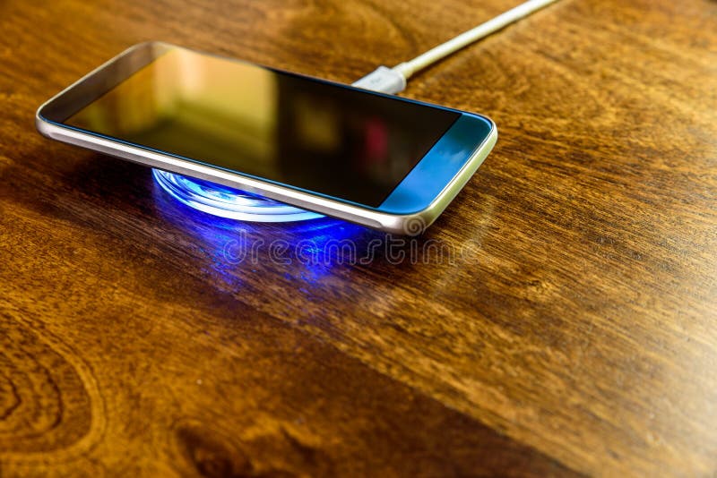 Smartphone charging on a charging pad. Wireless charging