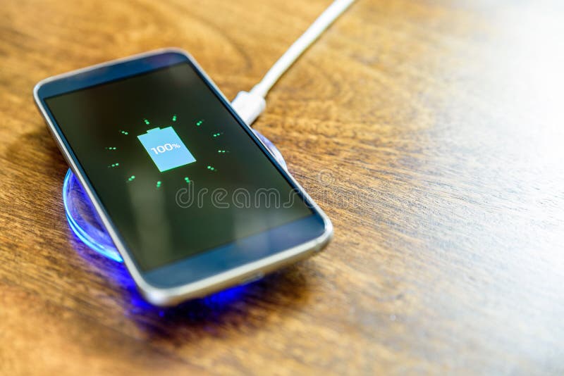 Smartphone charging on a charging pad. Wireless charging