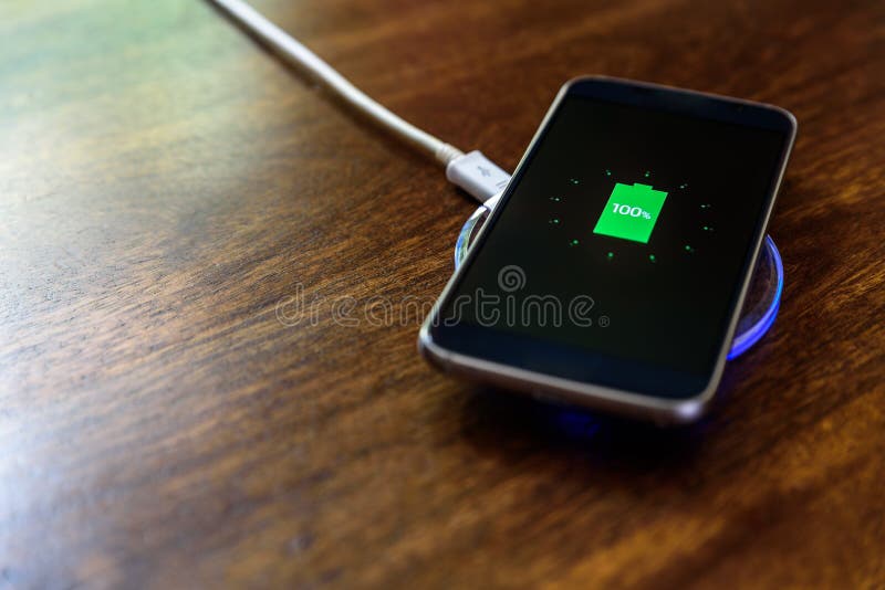 Smartphone charging on a charging pad. Wireless charging