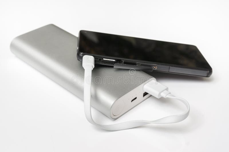 Smartphone de remplissage de la banque blanche de puissance photo stock Smartphone de remplissage de la banque blanche de puissance photo stock