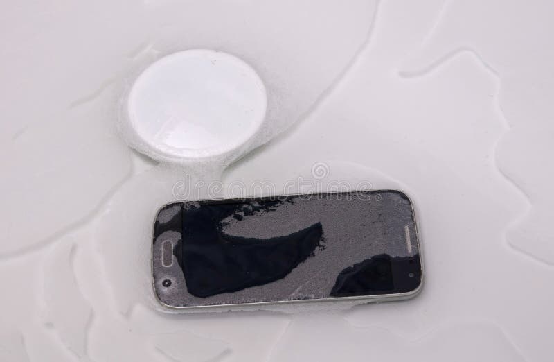 Smartphone is Lying in the Water Fallen in the Bathtub Stock Image