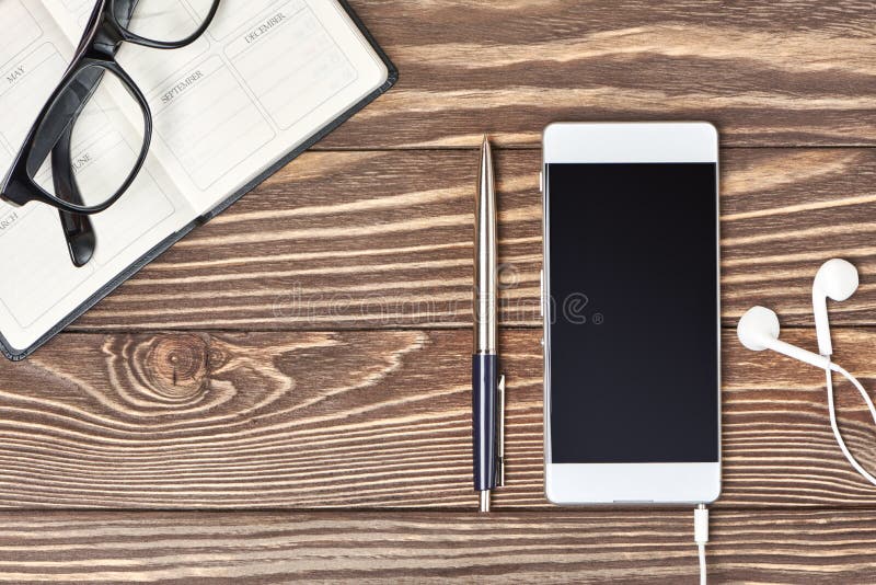 Smartphone, notebook and headphones on wooden background stock photos Smartphone, notebook and headphones on wooden background stock photos