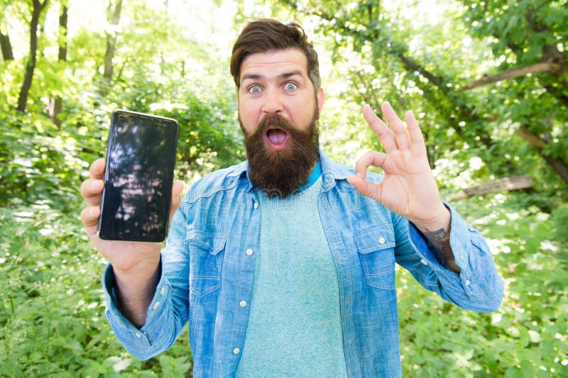 Smartphone online navigation system. Route for exciting adventure. Best GPS and navigation apps. Man bearded wanderer stock image