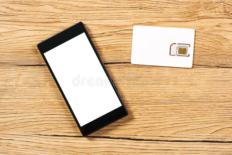 Smartphone and SIM Card on Office Table, Top View Stock Photo Image