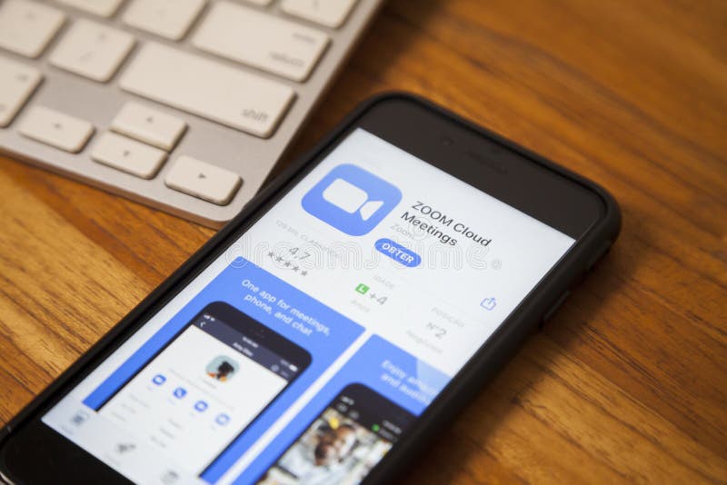 São paulo, Brazil. Feb 06, 2021: Smartphone on the table with open zoom application ready to be downloaded, app for making video conference calls. video call concept.