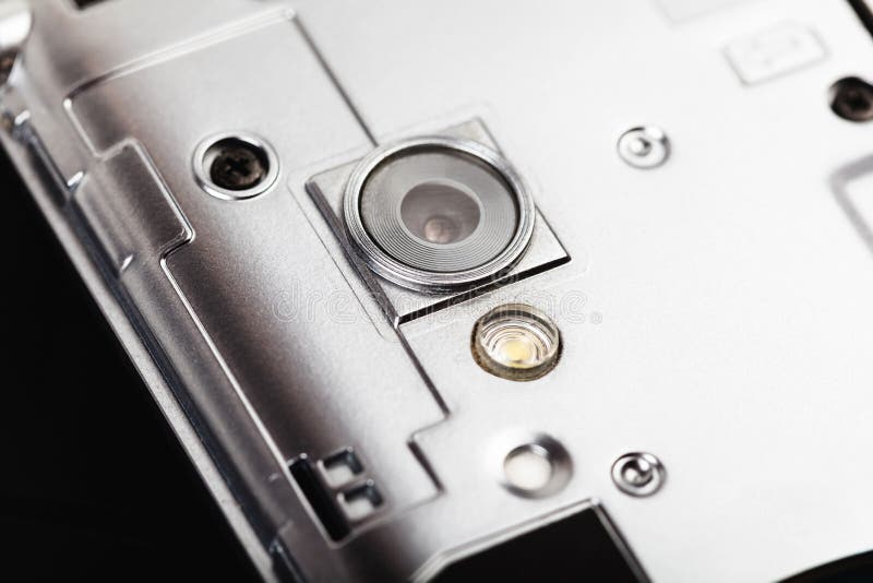 Smartphone taken apart, camera lens, macro, extreme closeup. Mobile phone teardown, disassembly tech service repairs abstract stock photography