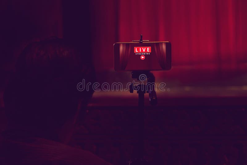 Smartphone on tripod wait for video live streaming in theater